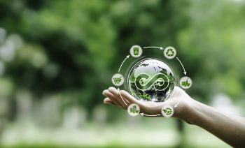 Hand-holding crystal globe with icon circular economy for carbon credit and CO2 emissions reduction. materials and products to reuse and renewable material resources, reuse, renewable, and repair,